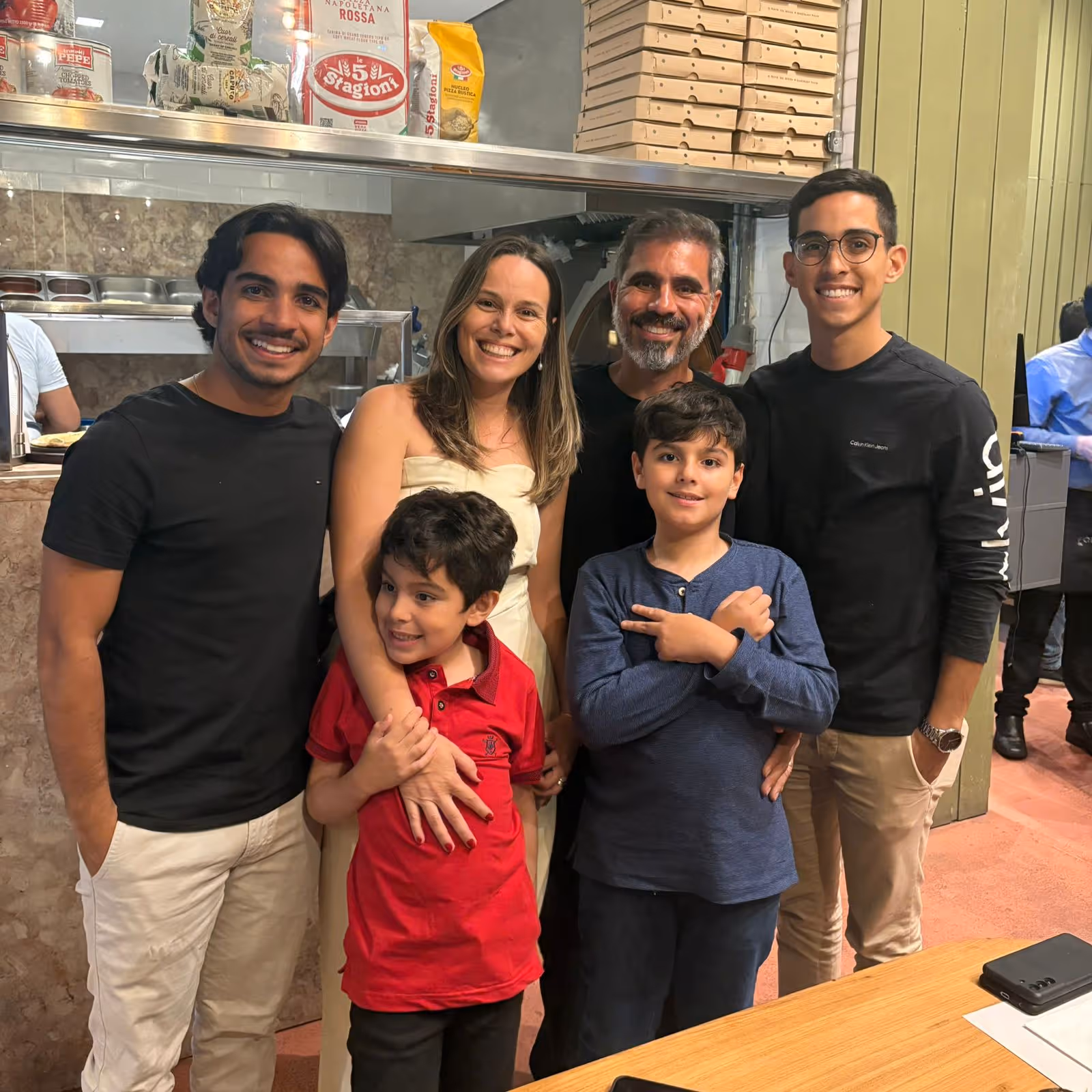 João with his family at a pizzeria