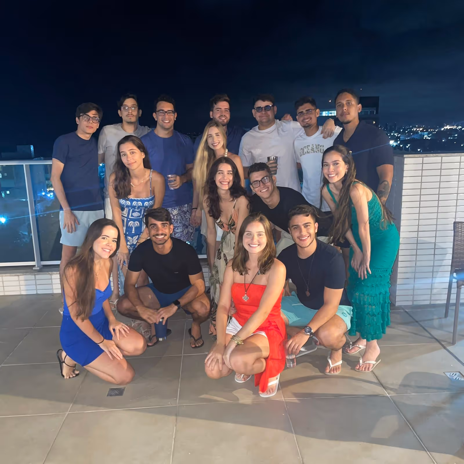 João with a big group of friends on a rooftop at night