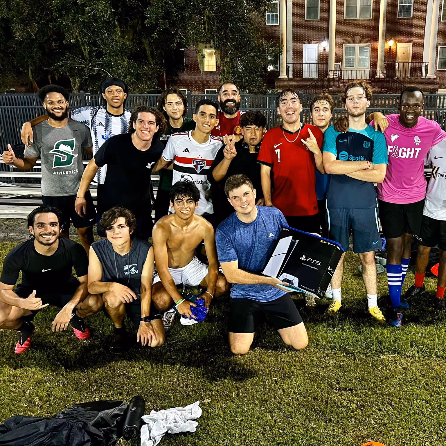 João with his football team on the pitch at night